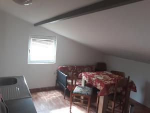 a room with a table and chairs and a window at Guest House Olga in Budva