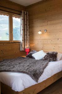 1 dormitorio con 1 cama en una habitación de madera en Résidence Vanoise, en Méribel