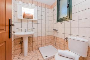 a bathroom with a toilet and a sink at Giovanna Studios in Keri