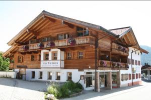 a large wooden building with a balcony at Beim Nuihausa in Reit im Winkl