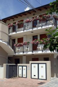 a building with several windows and balconies with flowers at Hotel Ristorante Cigno in Latisana
