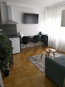 a living room with a couch and a table at Apartments Ali in Zagreb