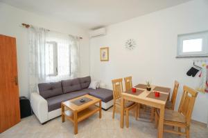 a living room with a couch and a table at Apartments Titonel in Savudrija