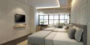 - une chambre avec 2 lits et une télévision à écran plat dans l'établissement Tori Prestige Bangkok Hotel, à Bangkok