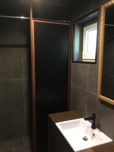 a bathroom with a white sink and a shower at le dépot 2 appartement 406 in Malmedy +17 photos