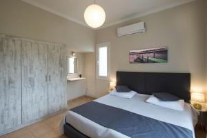 a bedroom with a large bed in a room at Georgia's Apartments, Ipsos - Complex S in Ýpsos +36 photos