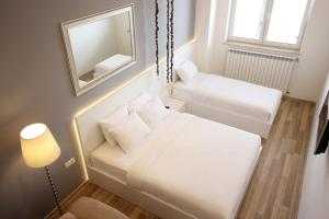 a small room with two beds and a mirror at Maxela Apartments in Tbilisi City
