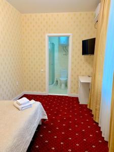 Postel nebo postele na pokoji v ubytování Sergeev Hotel