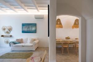 a living room with a white couch and a table at roques in Ciutadella