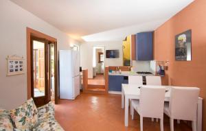 a kitchen and living room with a table and chairs at VIOLINA casa vacanze in Pettenasco