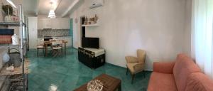a living room with a couch and a table at Residence Baia Infreschi in Marina di Camerota
