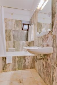 a bathroom with a sink and a mirror at Hotel Mar A Vista in Albufeira