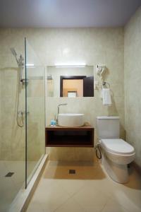 a bathroom with a toilet and a sink and a shower at Hotel Sani Kutaisi in Kutaisi