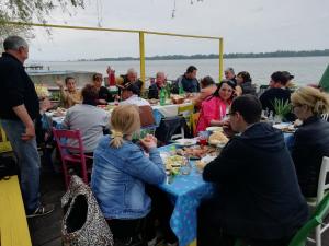 a group of people sitting at tables eating food at Angelinin Konak in Negotin