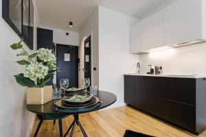 a kitchen and dining room with a table with wine glasses at Bob W Tallinn City Centre - Avangard in Tallinn