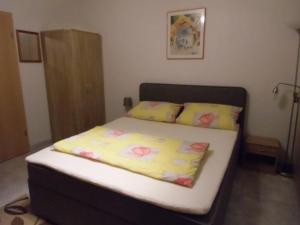 a bedroom with a bed with flowers on it at Ferienwohnung Keil in Lahr