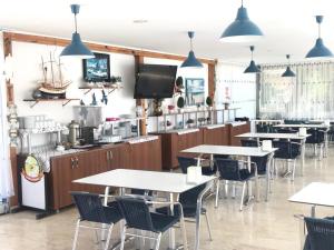 a restaurant with tables and chairs in a room at Rota Hotel in Dalyan