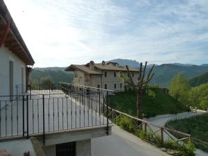 a house on a hill with a balcony at La Collina Del Tartufo in Ascoli Piceno