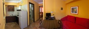 a living room with a red couch and a table at Residence Baia Infreschi in Marina di Camerota