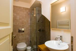 a bathroom with a toilet and a sink and a shower at Anastasia's Venetian House in Rethymno