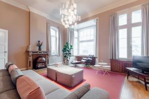 a living room with a couch and a tv at Maison Haas Hustinx & Spa in Maastricht