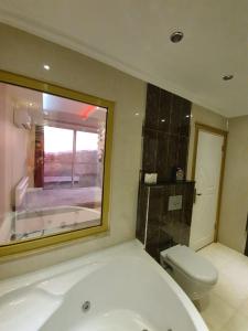 a bathroom with a bath tub and a toilet at panaroma villaları in Alanya
