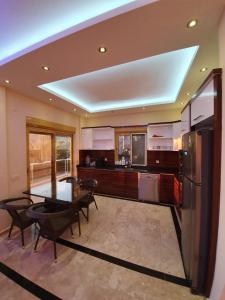 a large kitchen with a table and a refrigerator at panaroma villaları in Alanya