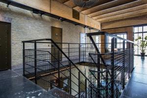 a spiral staircase in a room with a brick wall at Alibi Hostel Leeuwarden in Leeuwarden