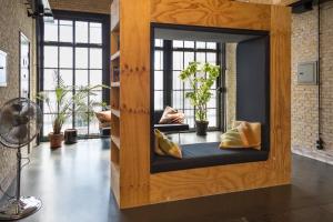 a living room with a large window and a large mirror at Alibi Hostel Leeuwarden in Leeuwarden