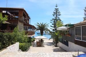 a patio with an umbrella next to a building at Hotel Cakalli in Sarandë