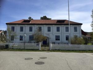 a white house with a white fence in front of it at Overgaard in Lillehammer