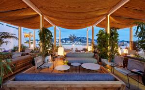 a pavilion with couches and tables and windows at Delamar 4*Sup-Adults only (18+) in Lloret de Mar