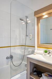 a bathroom with a shower and a sink at Aparthotel Adagio Access Nice Magnan in Nice