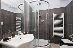 La salle de bains est pourvue d'un lavabo et d'une douche. dans l'établissement Locanda Paradiso, à Gênes