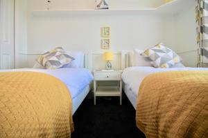 A bed or beds in a room at Seascape