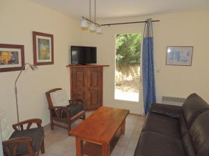 a living room with a couch and a table at Holiday Home in Buisson with Private Pool in Buisson