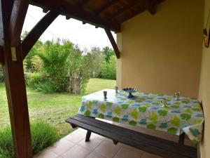 a table with a table cloth on a patio at Holiday home with private garden in Cazals