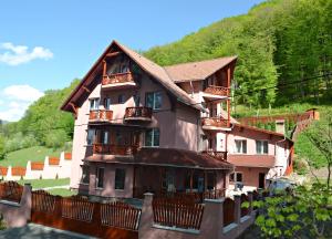 a large building with balconies on the side of it at Pensiunea Contesa in Sovata
