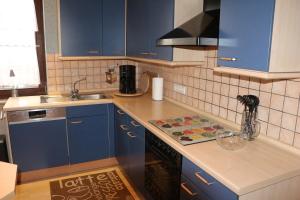 a kitchen with blue cabinets and a counter top at Susanne in Koblenz