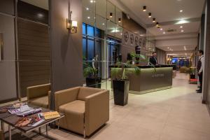 a lobby of a store with a chair and a table at City Avenue Hotel in Tbilisi City