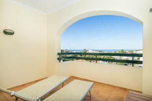 two benches in a room with a balcony at Mirachoro Carvoeiro in Carvoeiro