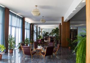 a restaurant with tables and chairs and plants at Stella Maris Casa per ferie sul mare in Anzio
