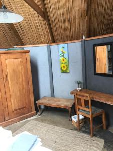 a room with a wooden bench and a table at BARE NECESSITIES, NUDIST ONLY VENUE Naturist, clothes free in Swellendam