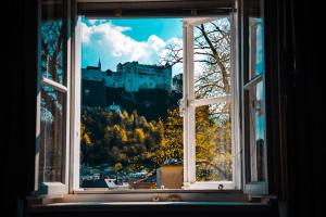 an open window with a view of a castle at APT. STONE-LODGE in Salzburg