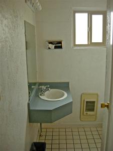 a bathroom with a sink and a window at Hub Motel in Redmond