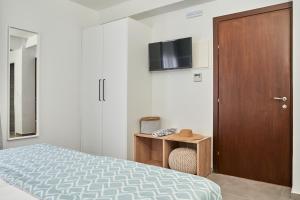 a bedroom with a bed and a wooden door at Mougre studios in Polychrono
