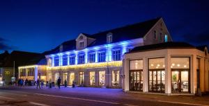 a building with blue lights on the side of it at Hotel Ry in Ry