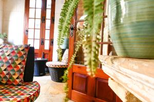 a room with potted plants sitting on a wall at Maria Giovanna Guest House in Marsalforn