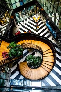 a spiral staircase with potted plants in a building at Only YOU Hotel Atocha in Madrid +69 photos