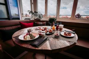 a wooden table with plates of food on it at Only YOU Hotel Atocha in Madrid